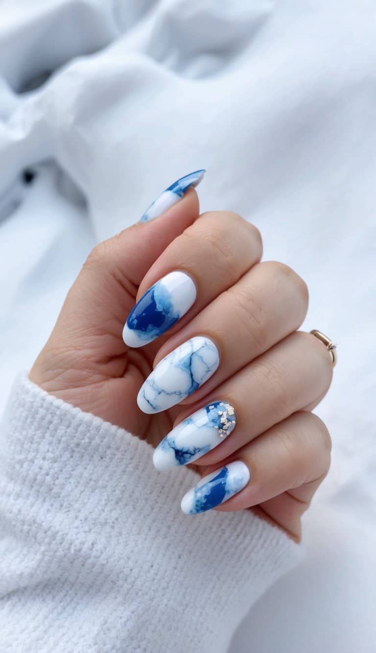 A snowy landscape with marble-like patterns in shades of white and blue, evoking a wintry December nail art theme