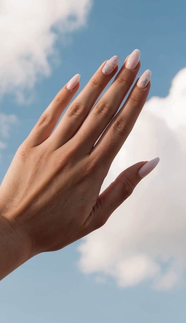 Fluffy white clouds against a pastel blue sky