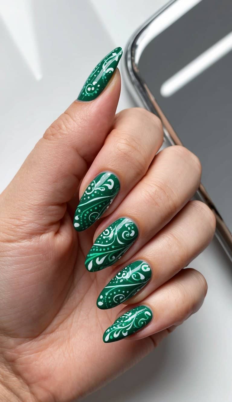 A close-up of emerald green paisley nail art on a sleek, elegant background