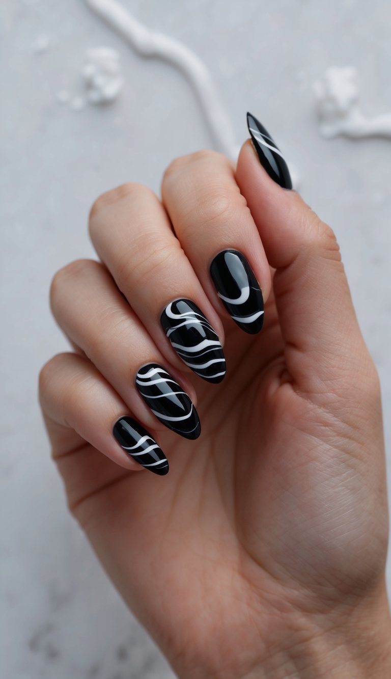 Black almond nails with fluid white wave lines for a minimalist, high-contrast emo-inspired nail design.