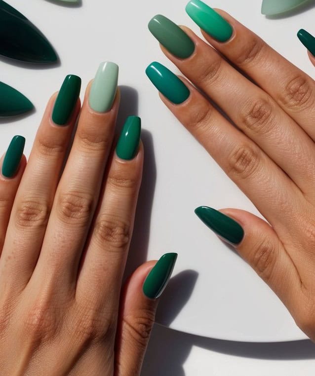 Stylish green ombre nails blending emerald, teal, and mint shades for a trendy and vibrant manicure.