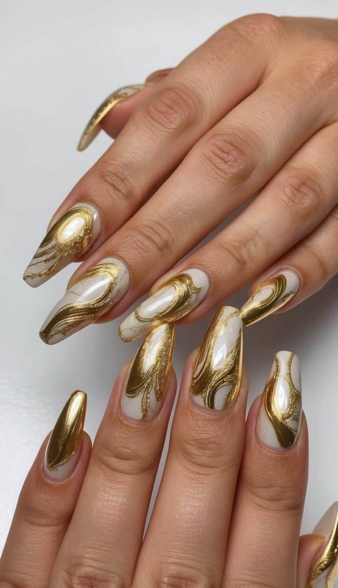 A luxurious gold marbling design on a set of nails, shimmering and reflecting light