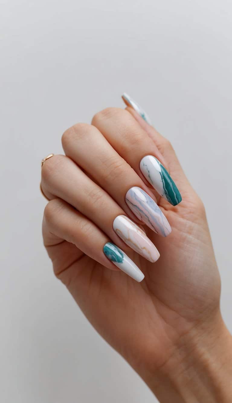 A set of marble effect nails in various colors and designs displayed on a clean, neutral background