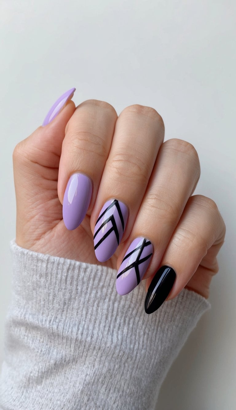 A lavender and black geometric nail art design on a clean, manicured nail