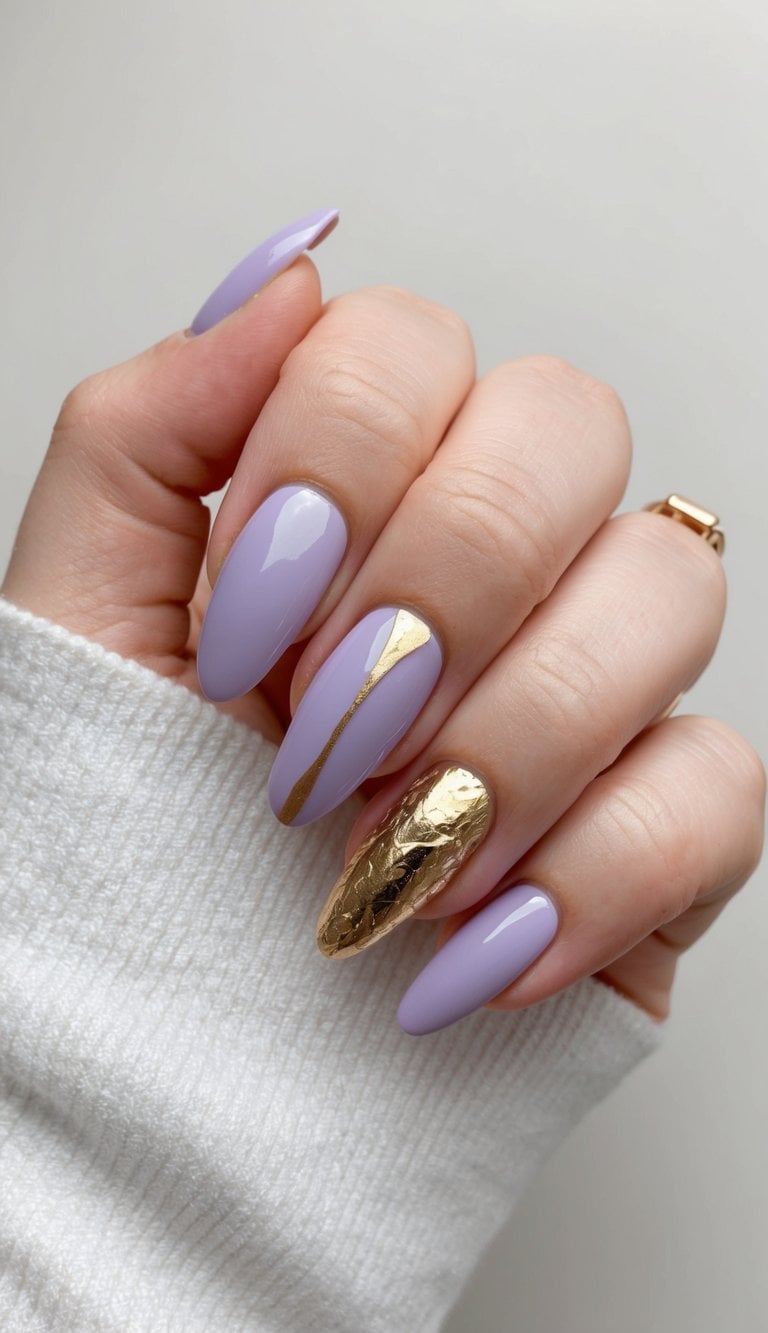 A delicate lavender nail art design with gold foil accents on a neutral background