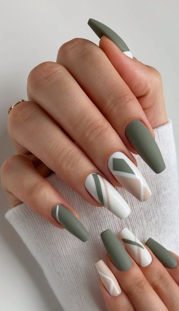 A clean, modern nail art design with subdued colors and minimalist geometric shapes