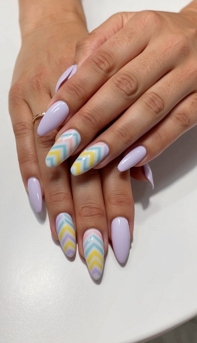 A table with pastel chevron patterned nail art designs displayed on nail tips