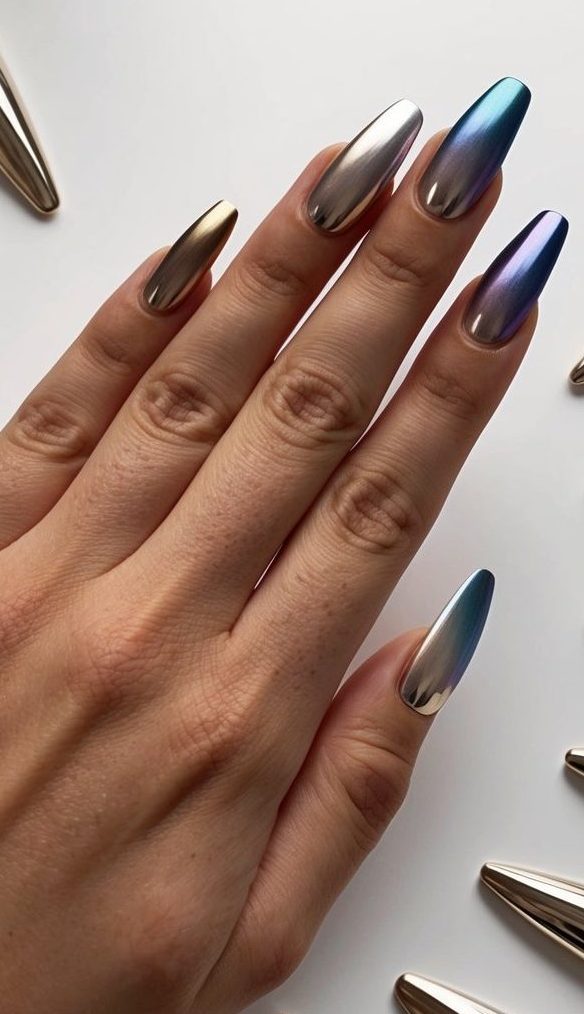 A hand with metallic ombre fade nails, surrounded by various metallic accent nail art designs