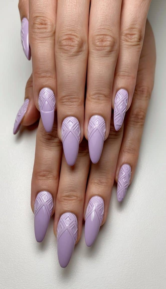 A close-up of lilac nails with intricate geometric patterns on a neutral background