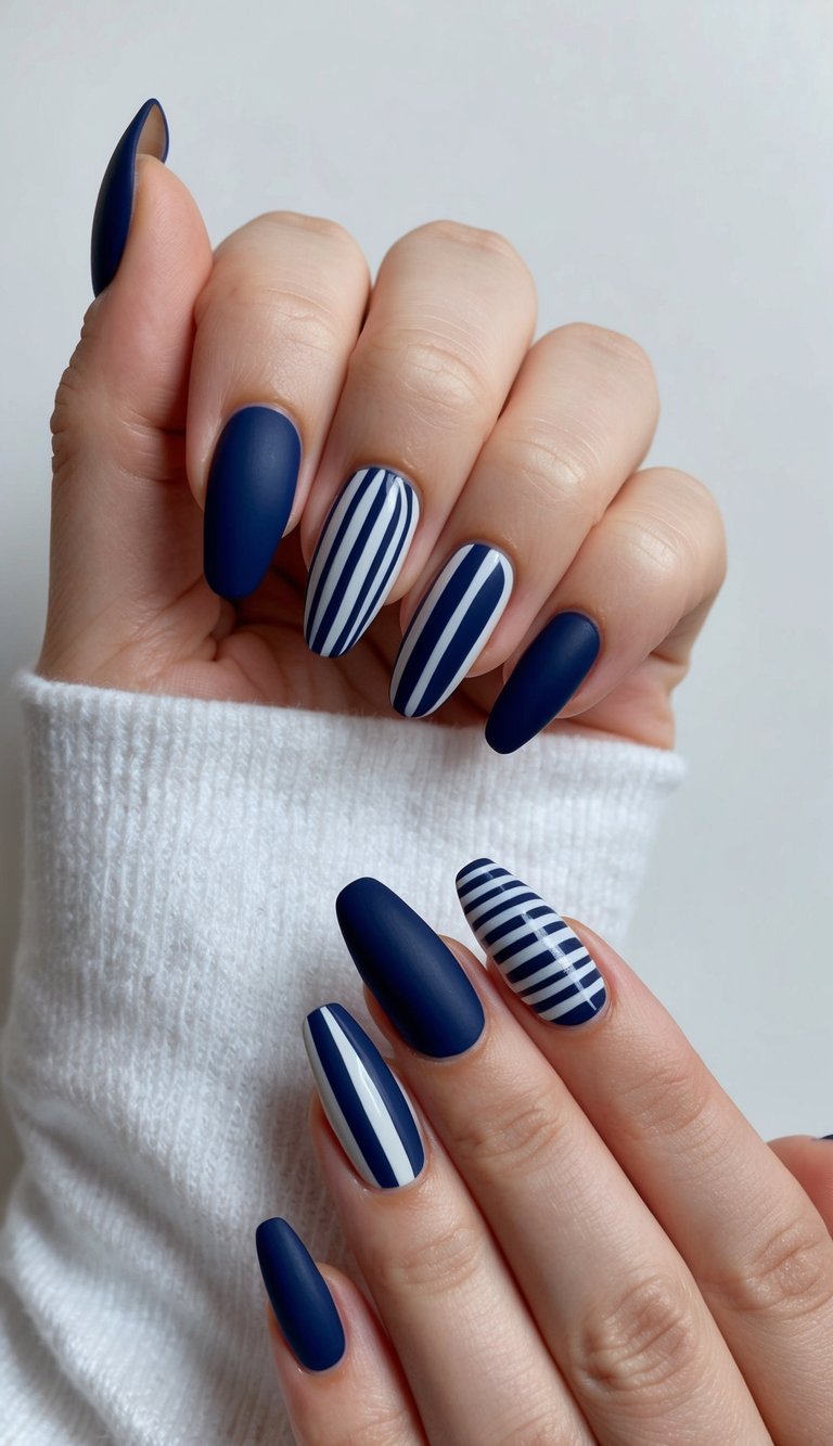 A navy nail art design featuring bold and classic patterns on a set of nails