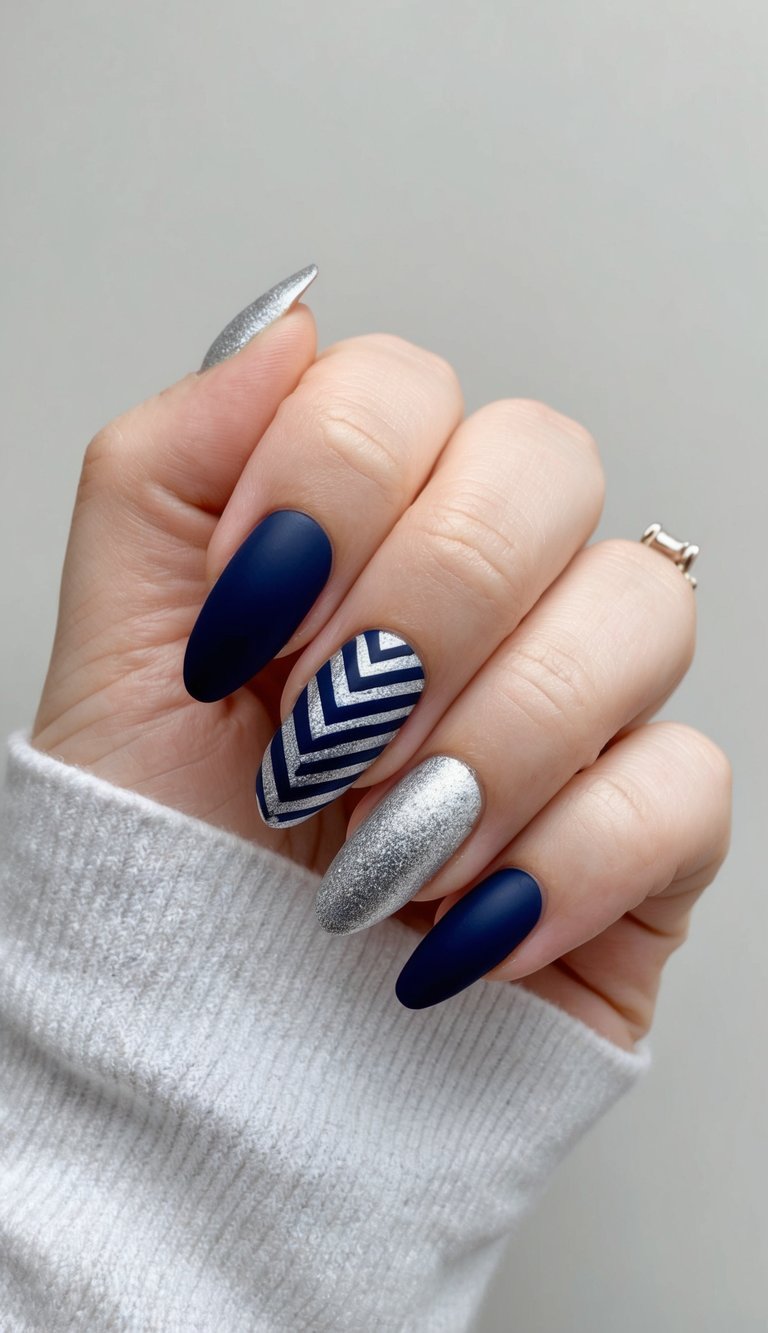 A navy and silver chevron nail design on a neutral background