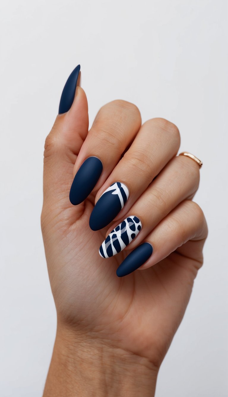 A navy nail art design featuring negative space and bold patterns