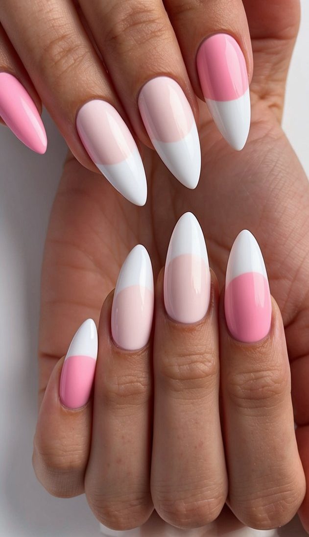 A manicured hand with alternating pink and white almond-shaped nails