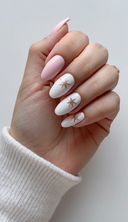 Pink and white nail polish on a clean, smooth surface with delicate white star designs