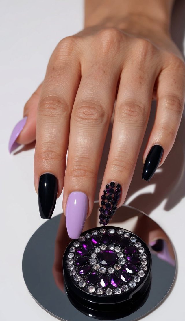 A hand holding a gem-studded purple and black nail art palette on a sleek, reflective surface