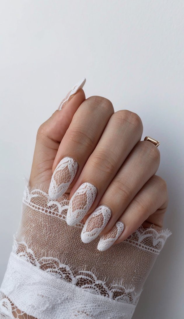 A set of nails with a delicate lace overlay design, showcasing a stylish and effortless look