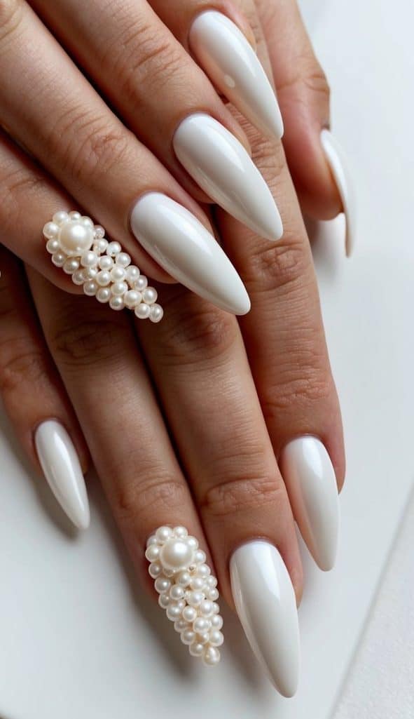 A set of pearl-embellished white nails arranged in a clean and classy display