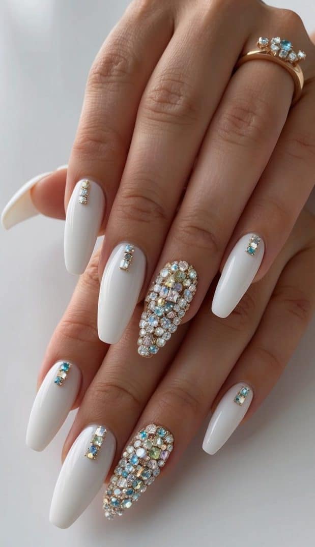 A set of elegant white nails adorned with sparkling rhinestones, exuding a clean and classy vibe
