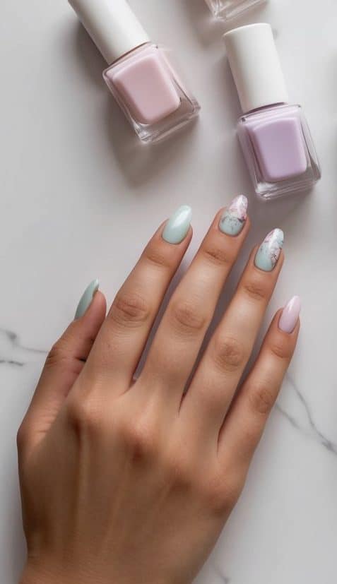 Soft pastel nail polish bottles arranged on a white marble surface with minimalistic decor