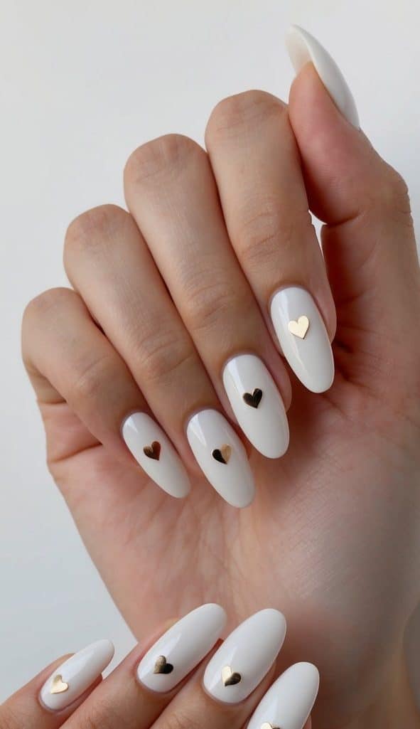Tiny heart accents adorn elegant nails
