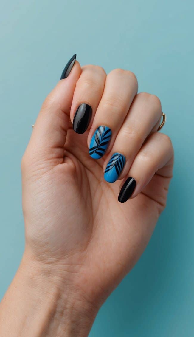 A close-up of black and blue nail art designs on a periwinkle background