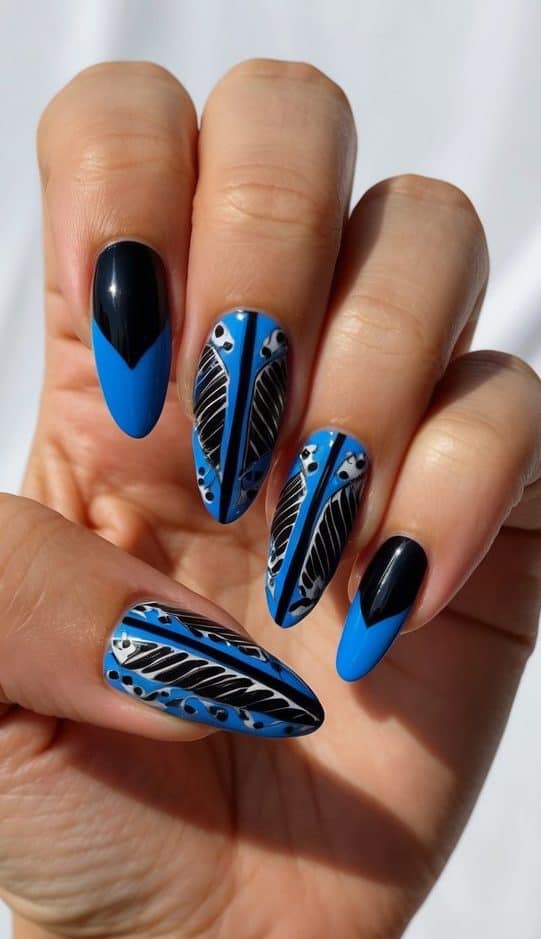 A sleek black and blue nail art design featuring intricate patterns and bold color contrasts