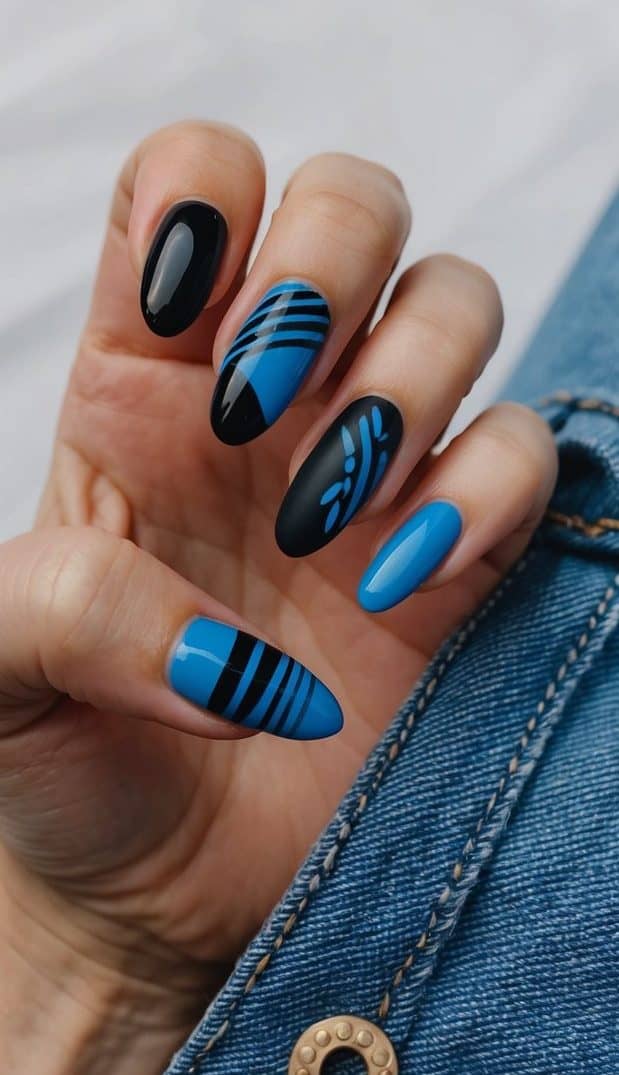 A close-up of black and blue nail art designs on denim fabric