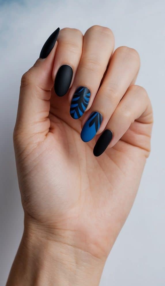 A close-up of black and blue nail art designs on a matte background with a subtle blue haze