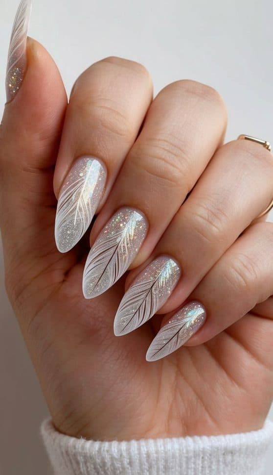 Feathered glitter designs on nails, sparkling under light