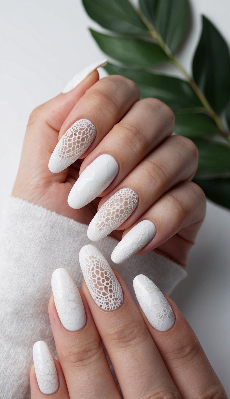 A close-up of white nails adorned with delicate lace patterns, some with a matte finish