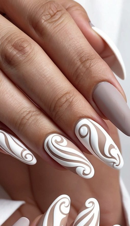 Nude nails with raised white swirl accents forming a sculptural, dimensional design across almond-shaped tips.