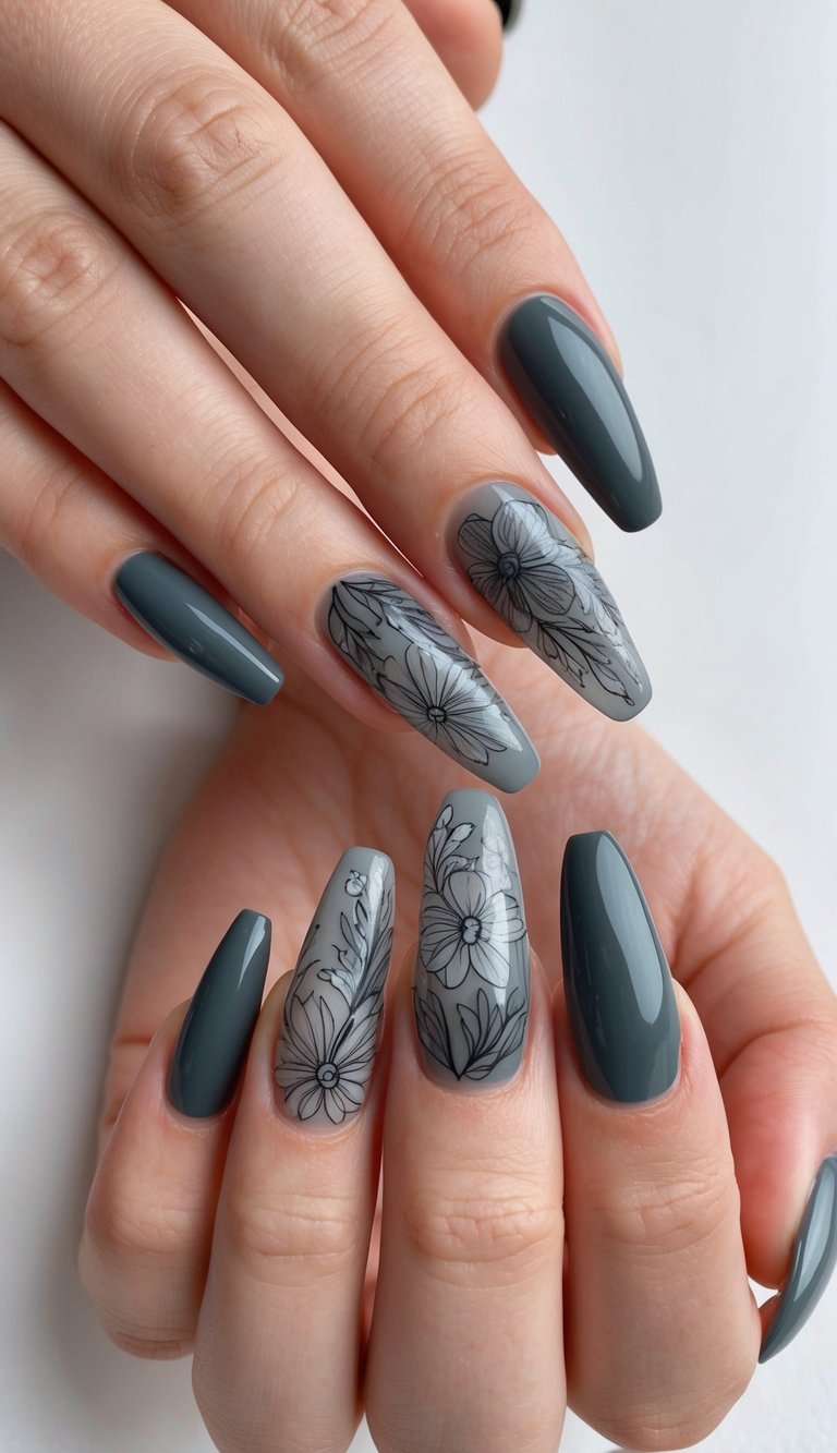 Almond-shaped nails featuring charcoal polish and romantic black floral prints on translucent gray accent nails for a chic, modern vibe.