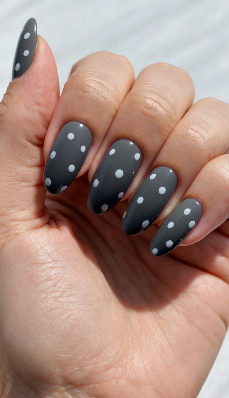 Glossy gray nails with classic white polka dots, combining a vintage-inspired pattern with a bold modern base.