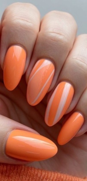 Manicure in soft orange with minimalist translucent lines for a fresh and refined take on vibrant nail art.