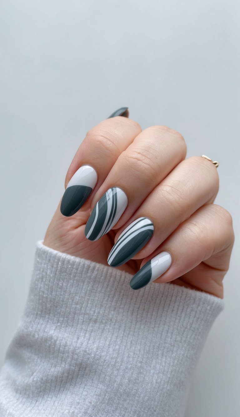 A sleek, elegant nail art design featuring swirling charcoal gray patterns on a clean, manicured surface