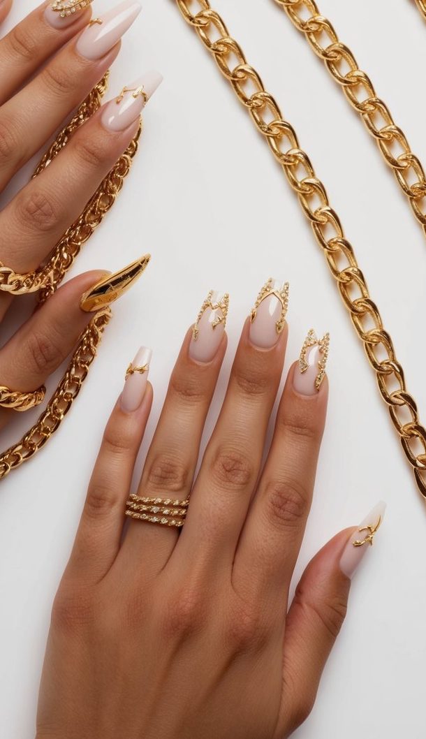 A collection of elegant gold chains arranged alongside glamorous gold nail art designs