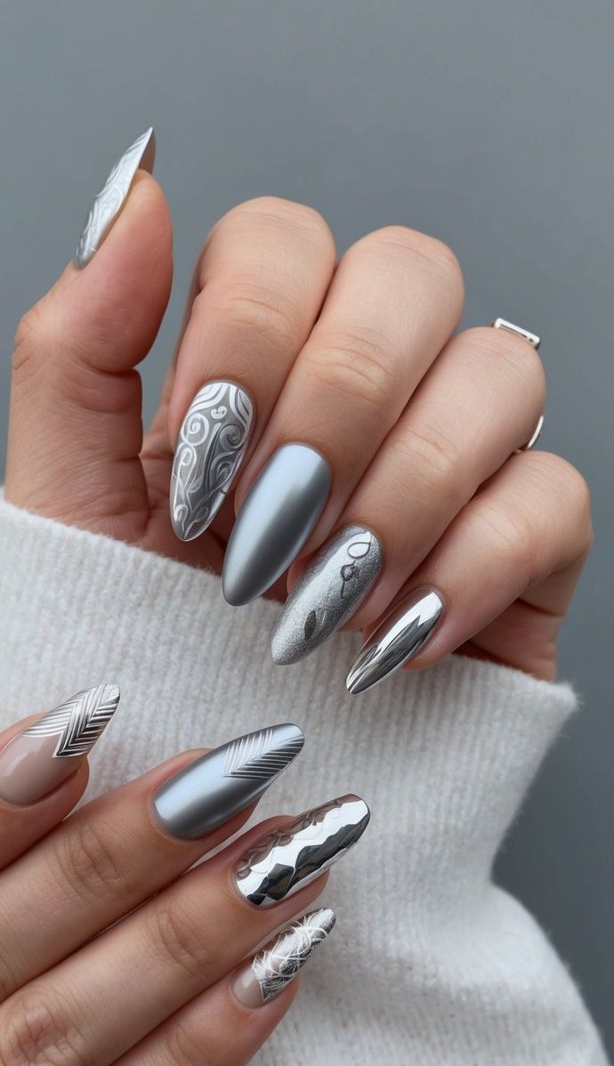 A matte grey background with sleek silver nail art designs in various patterns and styles