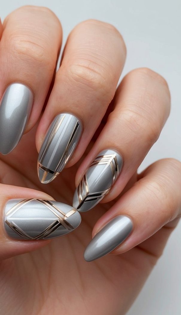A sleek silver nail art design with metallic accents and geometric patterns