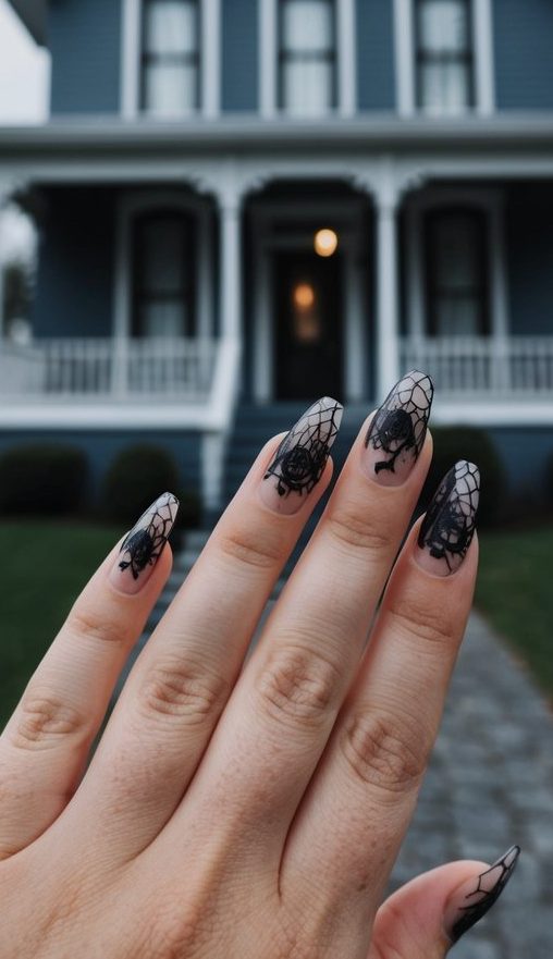 Matte nude nails decorated with detailed spider webs and 3D black widow-style spiders for a dramatic Halloween look.