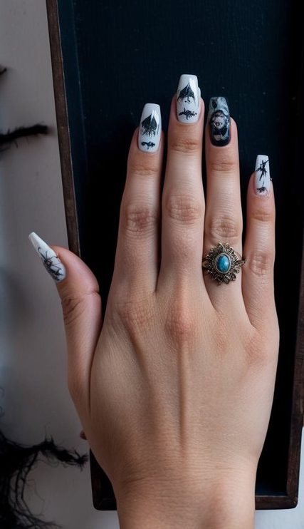 Halloween nails in black and white with witch silhouettes, fine spider details, and a gothic portrait accent for a moody, elegant vibe.