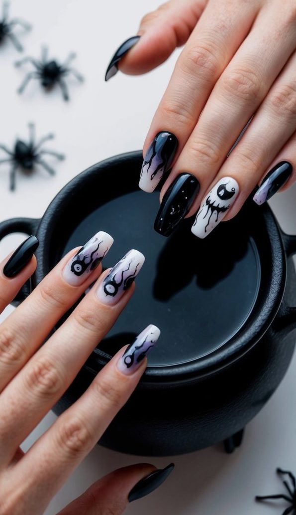 Halloween nails with black polish, faded white tips, dripping ghost designs, and bold graphic eyes for an edgy seasonal vibe.