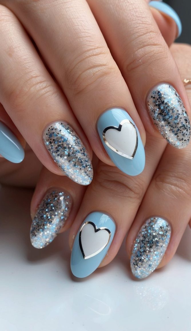 Sky blue nails paired with chunky silver glitter and statement white hearts with metallic silver outlines for a romantic yet modern look.
