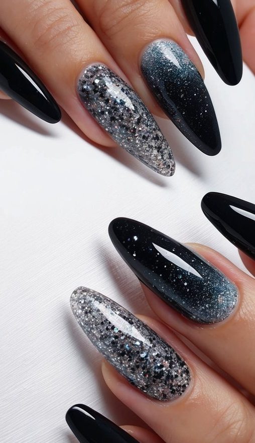 A close-up of black ombre nails with gradient glitter, showcasing intricate designs and blending techniques