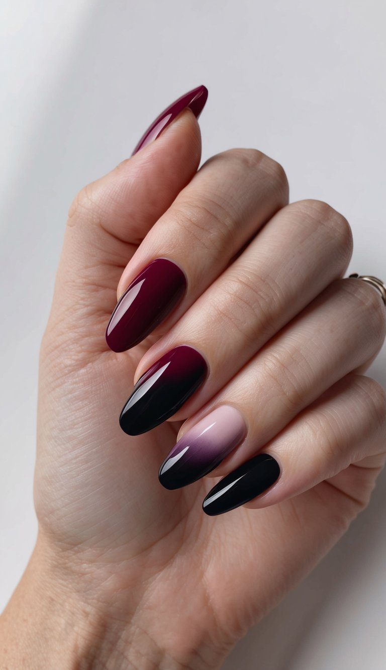 Almond nails featuring a gradient from black to burgundy and mauve shades, finished with a high-gloss top coat on a neutral background.