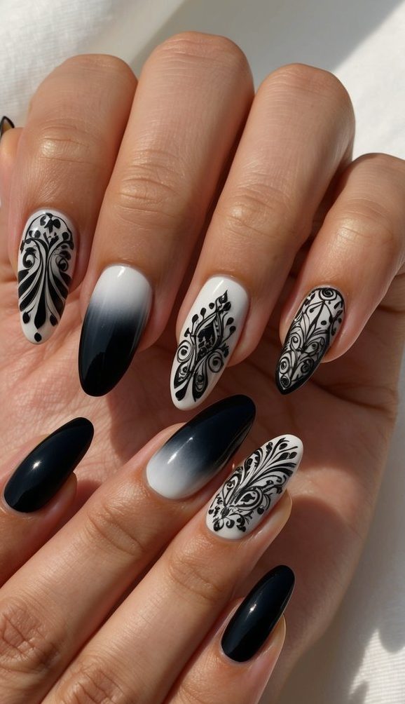 Almond-shaped nails with a mix of black ombré gradients and white nails featuring ornate black filigree patterns in baroque style.