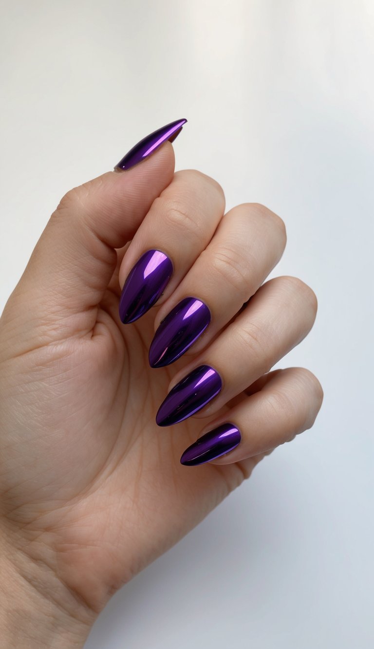 Glossy almond-shaped nails in a bold ultraviolet chrome polish reflecting light for a mirror-shine effect.
