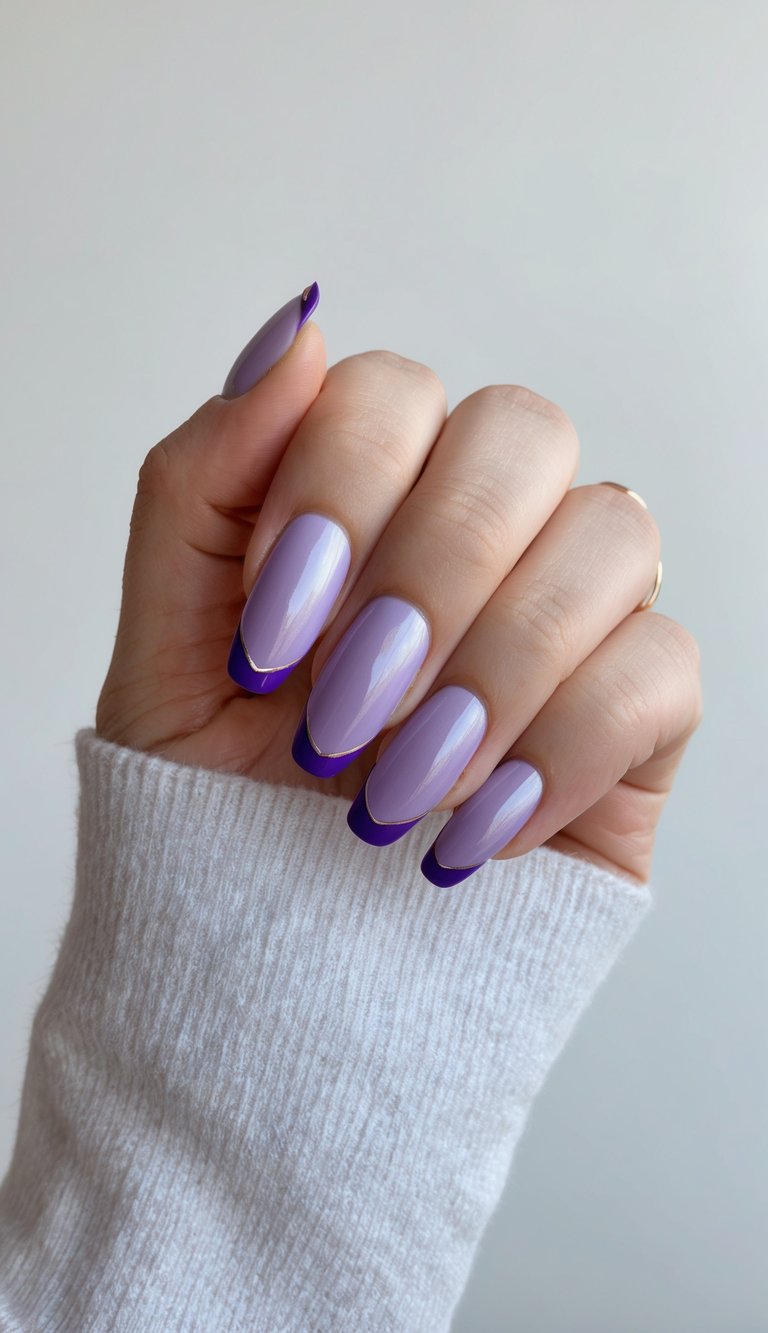 Squoval-shaped nails with a soft lavender base and bold plum French tips for a chic, minimal manicure.