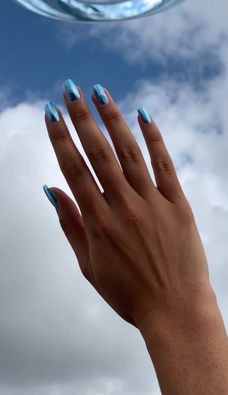 Cloudy sky with wisps of blue chrome swirling in the air