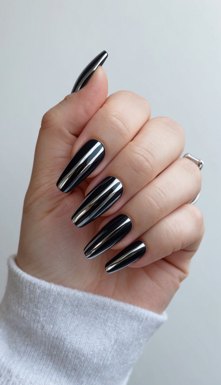 Long, tapered nails in ultra-reflective black chrome that mimic a high-shine, liquid mirror finish with a futuristic vibe.