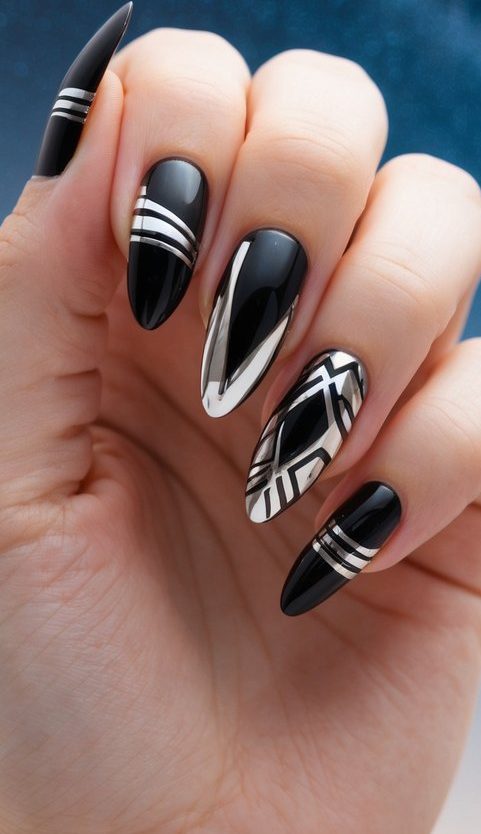 Almond-shaped nails in black polish with silver chrome accents and bold geometric striping for a sleek, high-contrast look.